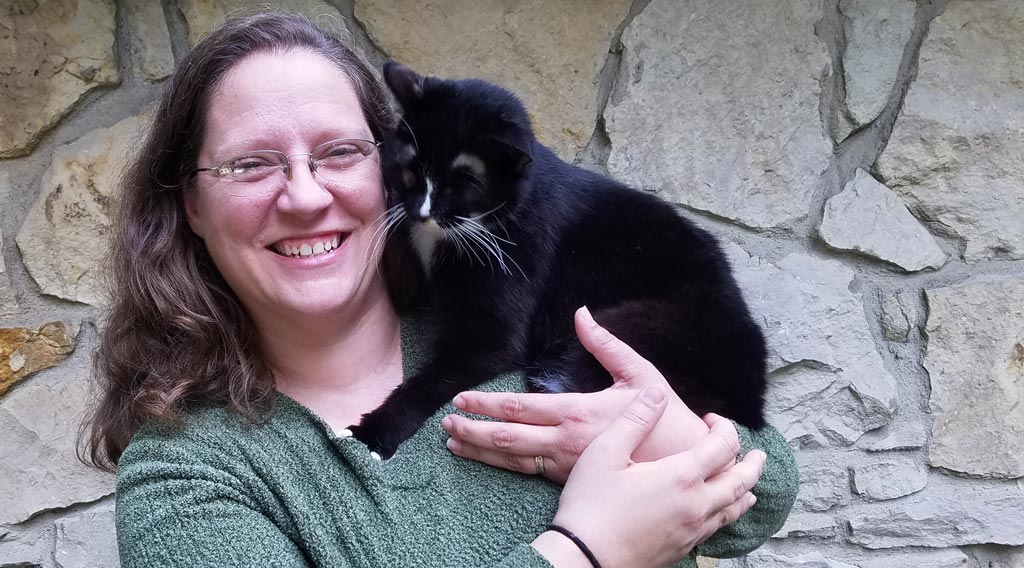 Kelli Barton, DVM, with her cat Copernicus on her shoulder