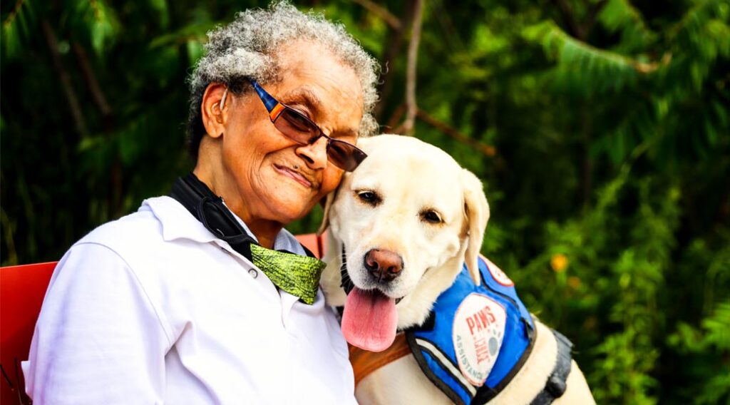 Older woman with yellow Labrador retriever